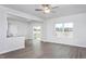 Open-concept living area with hardwood floors and sliding door access to deck overlooking backyard at 11640 International Dr, Middlesex, NC 27557