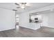 Bright, open-concept living room showcasing wood-look floors and a view into the modern kitchen at 11640 International Dr, Middlesex, NC 27557