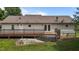 Home exterior with a wooden deck and patio in the backyard, ideal for outdoor entertaining and relaxation at 1167 John D Winstead Rd, Roxboro, NC 27574