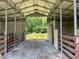 Spacious barn interior with metal structure and stalls offering potential for livestock or storage at 1167 John D Winstead Rd, Roxboro, NC 27574