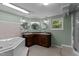 Bathroom with double sink, whirlpool tub, tile accents, and a separate shower for a spa-like experience at 1167 John D Winstead Rd, Roxboro, NC 27574