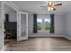 Large bedroom with updated flooring, neutral paint, and a window overlooking the exterior at 1167 John D Winstead Rd, Roxboro, NC 27574