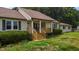 Attractive home with a welcoming front porch, wooden deck, and well-maintained landscaping at 1167 John D Winstead Rd, Roxboro, NC 27574