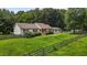 Charming home with a well-manicured lawn and a classic picket fence, surrounded by mature trees at 1167 John D Winstead Rd, Roxboro, NC 27574