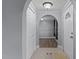 Bright hallway featuring an arched doorway, neutral paint, and durable flooring, offering a glimpse into other rooms at 1167 John D Winstead Rd, Roxboro, NC 27574
