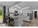 This open kitchen has stainless appliances, bar seating, and updated cabinets at 1167 John D Winstead Rd, Roxboro, NC 27574