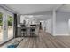 Spacious living room with updated flooring, bar seating, and exterior doors to the porch at 1167 John D Winstead Rd, Roxboro, NC 27574