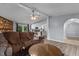 Cozy living room featuring an open layout with views of the kitchen and a charming stone fireplace at 1167 John D Winstead Rd, Roxboro, NC 27574
