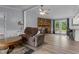 Cozy living room with a stone fireplace, exterior door, and updated flooring at 1167 John D Winstead Rd, Roxboro, NC 27574