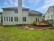 Spacious backyard with lush lawn, wooden deck, and mature trees offering privacy at 120 Point Harbor Dr, Cary, NC 27519