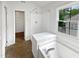 Bathroom featuring a garden tub with shower and window, as well as a walk-in closet at 120 Point Harbor Dr, Cary, NC 27519