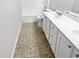Bathroom featuring double sink vanity with decorative knobs, mirror, and toilet with blue protective wrap at 120 Point Harbor Dr, Cary, NC 27519
