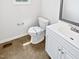 Clean half-bathroom with white toilet, mirror, and vanity with cabinet storage and tile flooring at 120 Point Harbor Dr, Cary, NC 27519