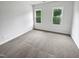 Neutral bedroom featuring two large windows offering ample natural light and neutral carpeting at 120 Point Harbor Dr, Cary, NC 27519