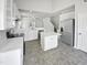 Bright kitchen features white cabinets, marbled countertops, stainless steel appliances and an island at 120 Point Harbor Dr, Cary, NC 27519