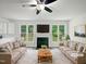 Bright living room with fireplace, ceiling fan, and large windows with lovely backyard views at 120 Point Harbor Dr, Cary, NC 27519
