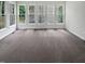 Bright sunroom featuring large windows offering ample natural light and neutral carpeting at 120 Point Harbor Dr, Cary, NC 27519