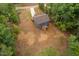 Aerial view of a blue home with a long driveway, surrounded by lush trees at 125 Oswego Dr, Louisburg, NC 27549