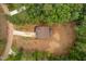 Aerial view reveals a two-story home, driveway, surrounded by mature trees on a spacious 0.77 acre lot at 125 Oswego Dr, Louisburg, NC 27549