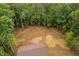 Aerial view reveals a backyard, the roof of the two-story home, and mature trees on the property at 125 Oswego Dr, Louisburg, NC 27549