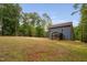 Expansive backyard shows lush green grass surrounded by mature trees and a two-story home with blue siding at 125 Oswego Dr, Louisburg, NC 27549