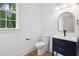 Bathroom with modern vanity, stylish mirror, and natural light at 125 Oswego Dr, Louisburg, NC 27549