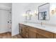 Bathroom with a double vanity, quartz countertops, updated lighting, and stylish mirrors at 125 Oswego Dr, Louisburg, NC 27549