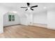 Spacious bedroom featuring hardwood floors, a ceiling fan, a window and a built-in bench at 125 Oswego Dr, Louisburg, NC 27549