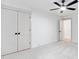Bright bedroom with plush carpet, ceiling fan, and closet access at 125 Oswego Dr, Louisburg, NC 27549
