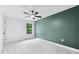Bedroom with carpet, ceiling fan, window with a green view, and accent wall at 125 Oswego Dr, Louisburg, NC 27549