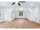 Cozy bedroom with vaulted ceiling, hardwood floors, ceiling fan, and a window view at 125 Oswego Dr, Louisburg, NC 27549