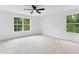 Bedroom with carpet, a ceiling fan, two windows, and neutral décor at 125 Oswego Dr, Louisburg, NC 27549