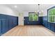 Bright dining room featuring stylish wainscoting, a modern chandelier and wood flooring at 125 Oswego Dr, Louisburg, NC 27549