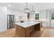 Kitchen boasts a large center island with wooden accents and modern stainless appliances at 125 Oswego Dr, Louisburg, NC 27549