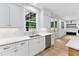 Bright kitchen features stainless steel appliances, modern white countertops and cabinetry at 125 Oswego Dr, Louisburg, NC 27549