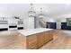 Open-concept kitchen with center island, designer lighting, stainless appliances, and open to the living area at 125 Oswego Dr, Louisburg, NC 27549