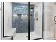 Modern walk-in shower with blue tile accent wall and built-in bench seating at 125 Oswego Dr, Louisburg, NC 27549