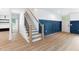 Staircase with decorative blue wainscoting and modern railing at 125 Oswego Dr, Louisburg, NC 27549