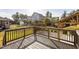 Wooden deck overlooks fenced-in backyard with pergola, stone pathway and manicured lawn at 130 Virginia Water Dr, Rolesville, NC 27571