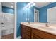 Well-lit bathroom with a double vanity and shower-tub combo at 130 Virginia Water Dr, Rolesville, NC 27571