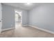 Neutral-toned bedroom features plush carpet and a doorway to another living space at 130 Virginia Water Dr, Rolesville, NC 27571