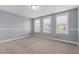 Carpeted bedroom with three large windows allowing for plenty of natural light at 130 Virginia Water Dr, Rolesville, NC 27571