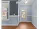 Dining space with outside access and hardwood floors, complemented by wainscotting and fresh paint at 130 Virginia Water Dr, Rolesville, NC 27571