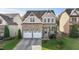 Charming two-story home featuring a stone facade, attached two-car garage and beautifully landscaped front yard at 130 Virginia Water Dr, Rolesville, NC 27571
