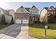 Beautiful two-story home with a stone facade and a two-car garage at 130 Virginia Water Dr, Rolesville, NC 27571