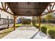Covered patio area featuring stone pavers and a modern hanging light fixture at 130 Virginia Water Dr, Rolesville, NC 27571
