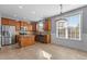 Bright kitchen featuring stainless steel appliances, granite counters, tile floors, and ample cabinet space at 130 Virginia Water Dr, Rolesville, NC 27571