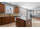 Bright kitchen features stainless steel appliances, granite counters, tile floors, and a center island at 130 Virginia Water Dr, Rolesville, NC 27571