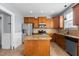 Bright kitchen features stainless steel appliances, granite counters, tile floors, and a center island at 130 Virginia Water Dr, Rolesville, NC 27571