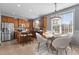 Bright kitchen featuring stainless steel appliances, granite counters, tile floors, bar seating, and breakfast nook at 130 Virginia Water Dr, Rolesville, NC 27571